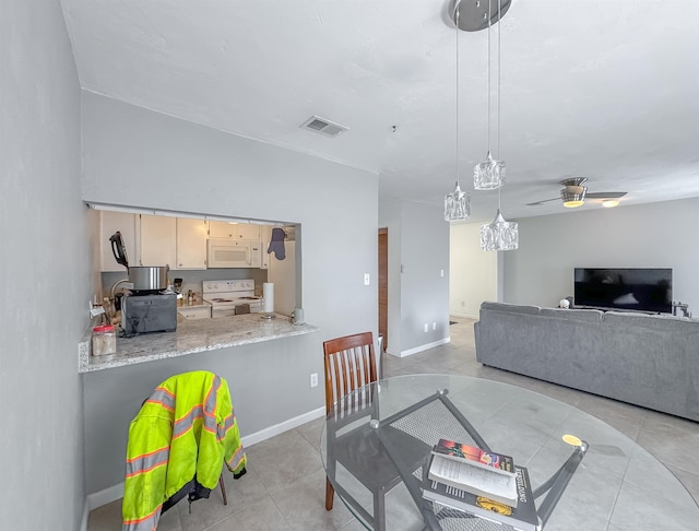 1319 Airport Dr Unit F04, Tallahassee, FL 32304 - dining space featuring light tile patterned floors, ceiling fan, and baseboards