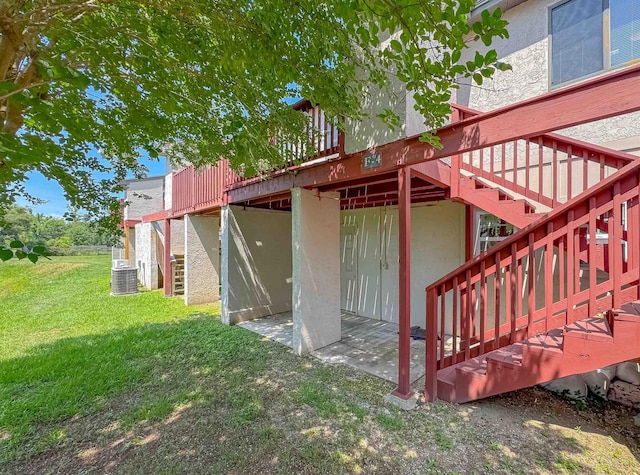 1319 Airport Dr Unit F04, Tallahassee, FL 32304 - rear view of house featuring stairway, a lawn, a deck, and stucco siding