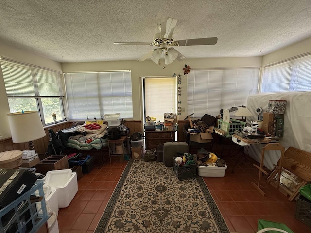 interior space with a ceiling fan, a healthy amount of sunlight, and tile patterned flooring