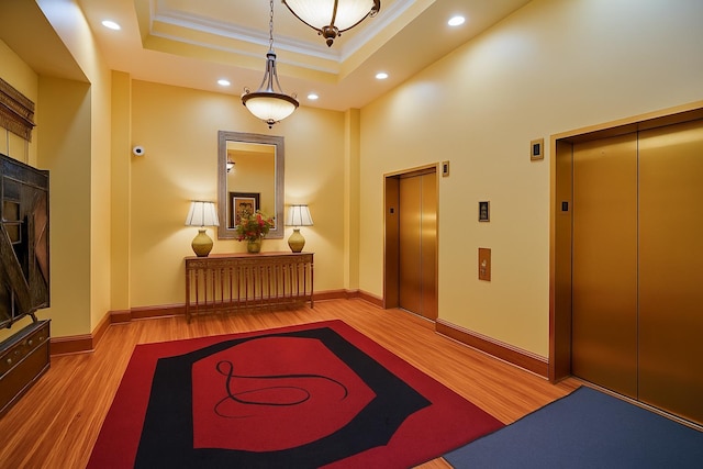 121 N Monroe St Unit 8007, Tallahassee, FL 32301 - hall featuring elevator, wood finished floors, a tray ceiling, ornamental molding, and recessed lighting