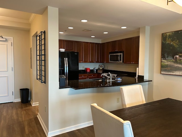121 N Monroe St Unit 8007, Tallahassee, FL 32301 - kitchen featuring black fridge, stainless steel microwave, a sink, dark wood finished floors, and a peninsula