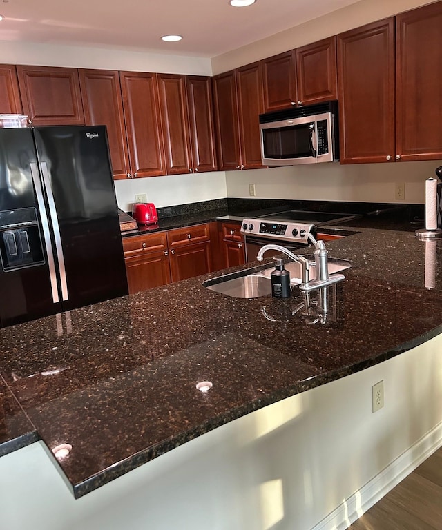 121 N Monroe St Unit 8007, Tallahassee, FL 32301 - kitchen featuring stainless steel appliances, recessed lighting, a sink, dark stone counters, and a peninsula