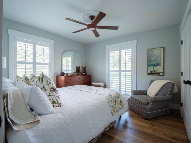 bedroom with ceiling fan and dark hardwood / wood-style floors