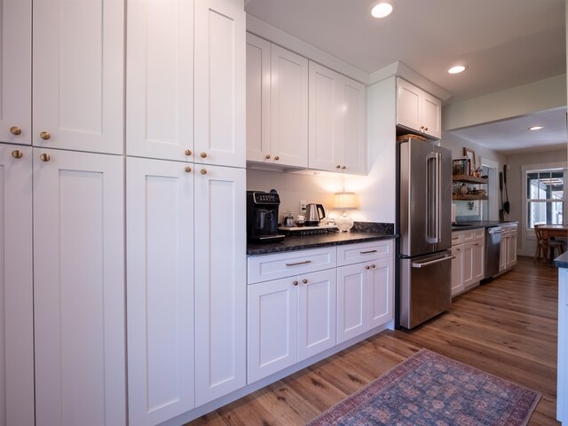 kitchen with white cabinetry, hardwood / wood-style flooring, and stainless steel appliances