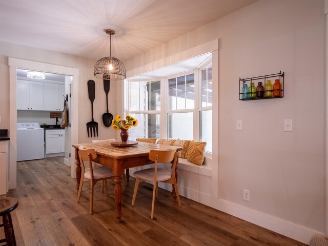 dining area with washer / clothes dryer and hardwood / wood-style flooring