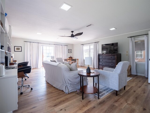 living room featuring ceiling fan and light wood-type flooring