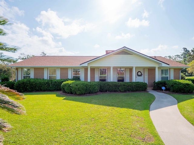 ranch-style home with a front lawn