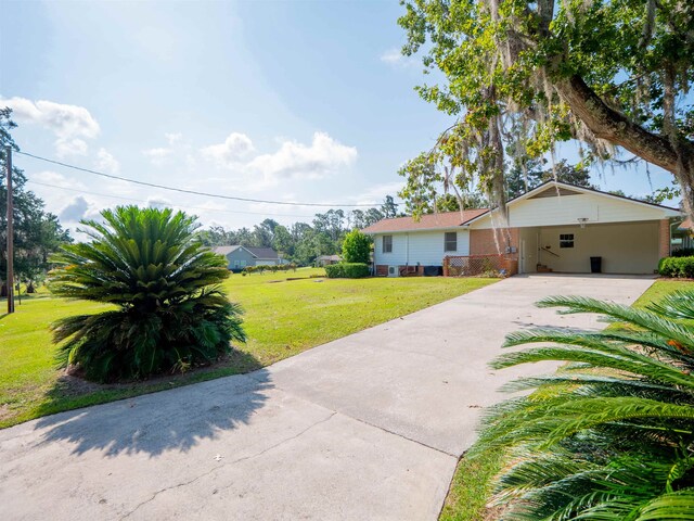 ranch-style home featuring a front yard and a carport