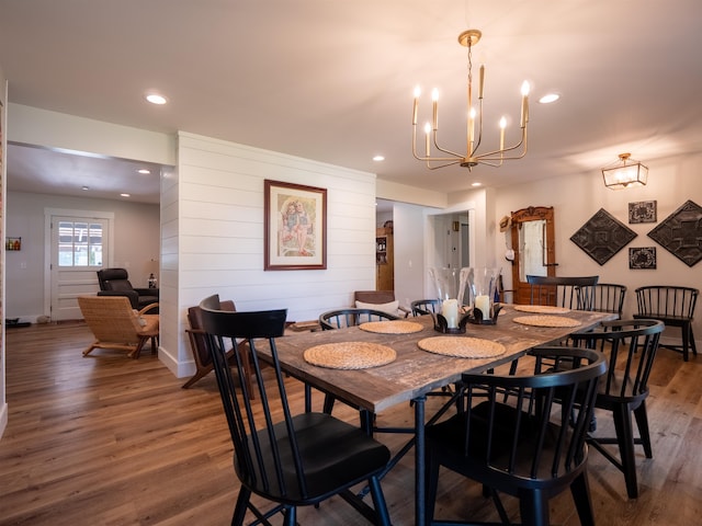 dining area featuring a chandelier and wood-type flooring