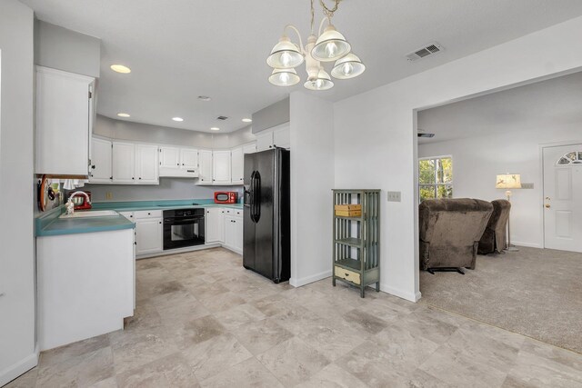 kitchen with sink, white cabinetry, hanging light fixtures, black appliances, and light colored carpet