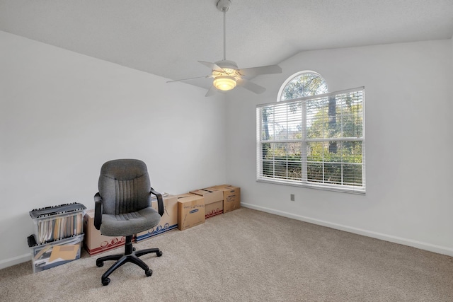 home office featuring ceiling fan, carpet, lofted ceiling, and a textured ceiling