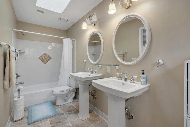 bathroom featuring toilet, a skylight, and shower / bath combo with shower curtain