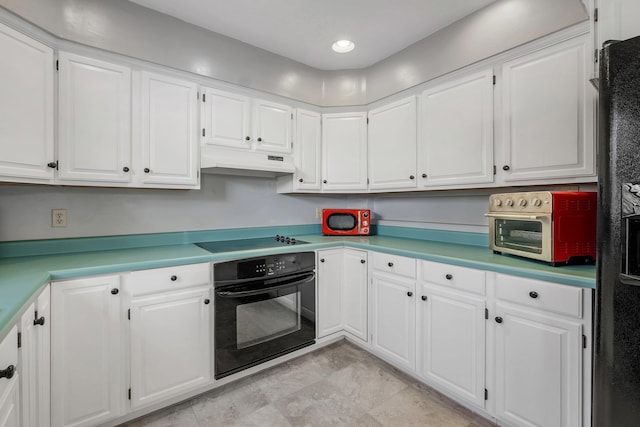 kitchen featuring white cabinets and black appliances