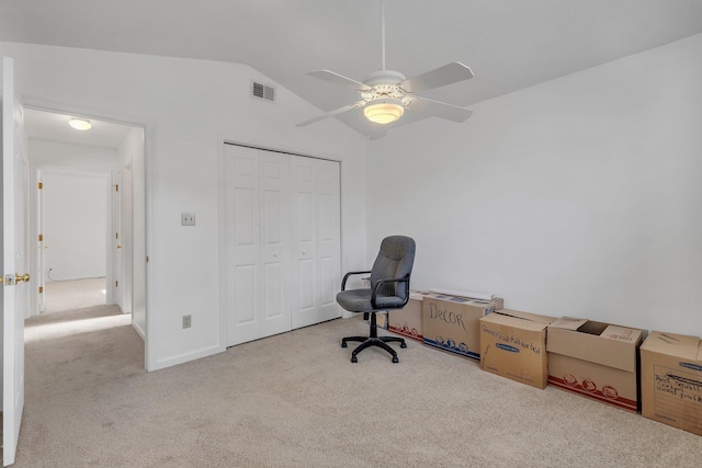 unfurnished office with lofted ceiling, light carpet, and ceiling fan