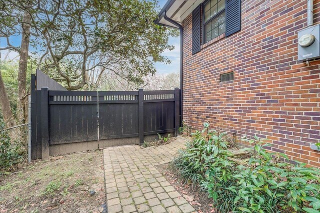 818 Watt Dr, Tallahassee, FL 32303 - view of gate featuring a patio area and fence