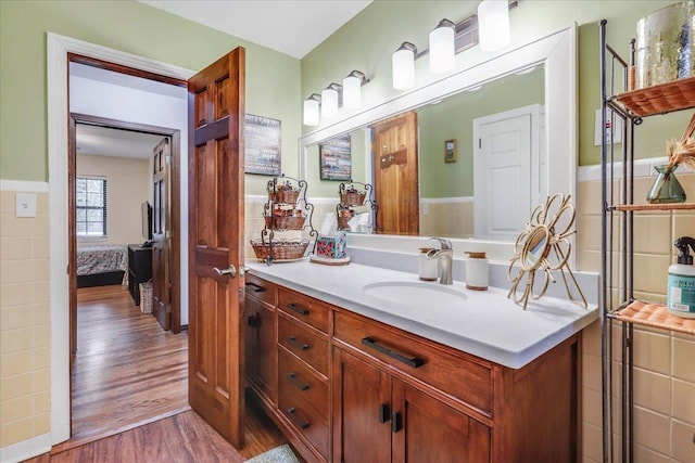 818 Watt Dr, Tallahassee, FL 32303 - bathroom featuring wood finished floors, connected bathroom, and vanity