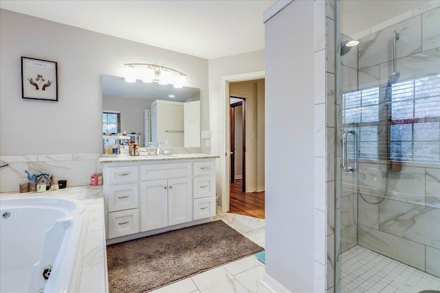 818 Watt Dr, Tallahassee, FL 32303 - bathroom featuring a stall shower, a garden tub, and vanity