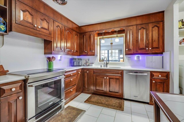 818 Watt Dr, Tallahassee, FL 32303 - kitchen with appliances with stainless steel finishes, light countertops, and a sink