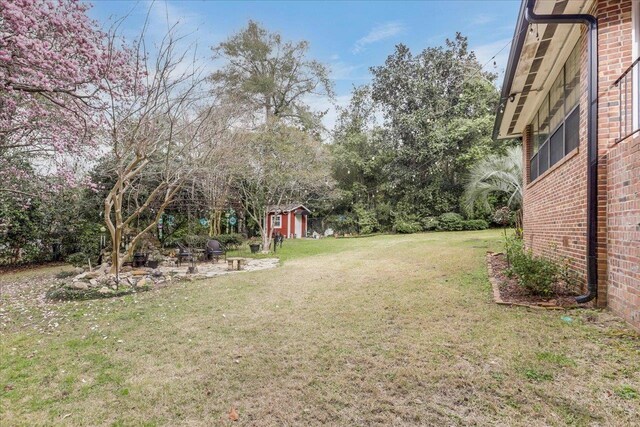 818 Watt Dr, Tallahassee, FL 32303 - view of yard featuring a storage unit and an outbuilding