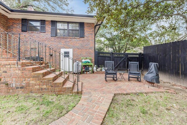 818 Watt Dr, Tallahassee, FL 32303 - view of patio with a gate, stairs, and fence