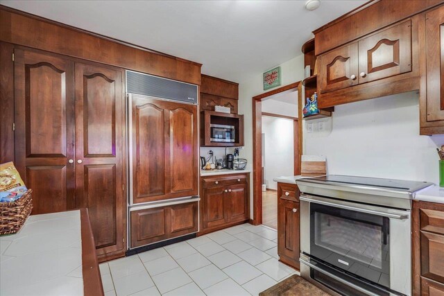 818 Watt Dr, Tallahassee, FL 32303 - kitchen with open shelves, appliances with stainless steel finishes, and light countertops