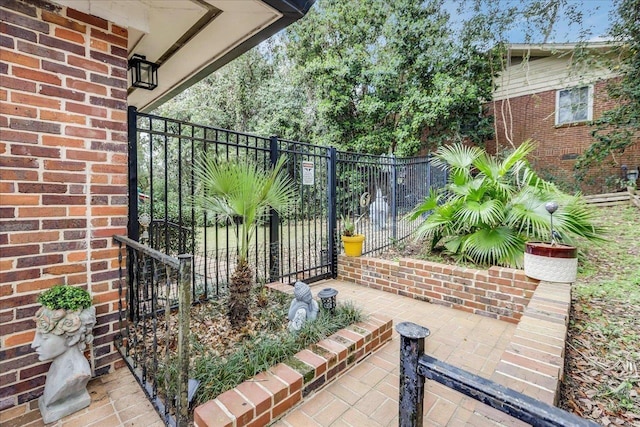 view of gate featuring a patio area and fence