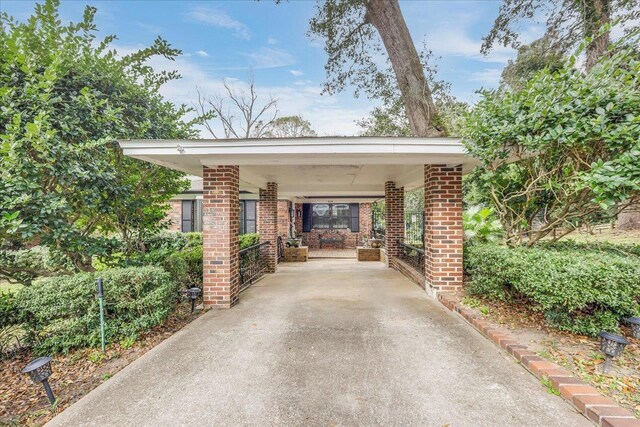 818 Watt Dr, Tallahassee, FL 32303 - view of car parking featuring a carport and concrete driveway