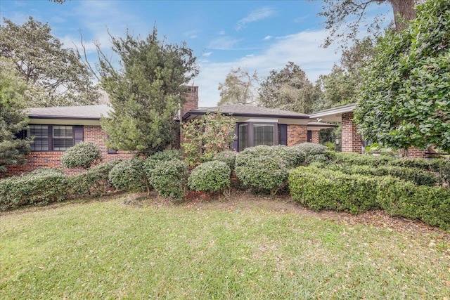 818 Watt Dr, Tallahassee, FL 32303 - single story home featuring brick siding, a chimney, and a front yard