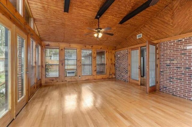 unfurnished sunroom with lofted ceiling, visible vents, and a ceiling fan