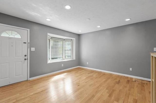 entryway with light wood-style flooring, baseboards, and recessed lighting