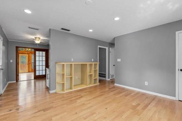 unfurnished room with light wood-style floors, baseboards, visible vents, and recessed lighting