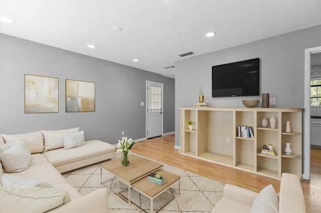 living room featuring baseboards, wood finished floors, visible vents, and recessed lighting