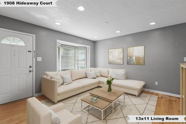 living room featuring recessed lighting, light wood-type flooring, and baseboards