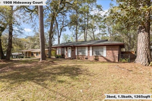 ranch-style home with brick siding and a front yard