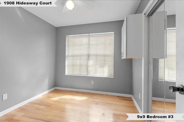 interior space featuring a ceiling fan, light wood-style flooring, baseboards, and a closet