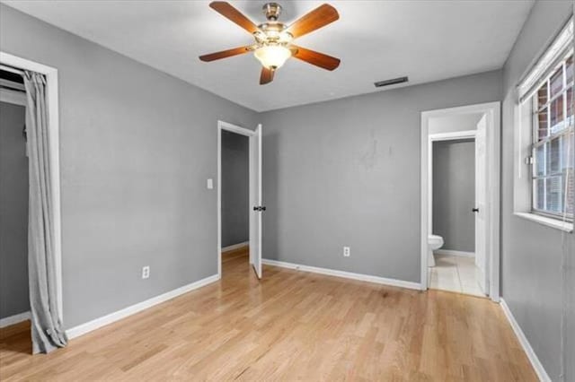 unfurnished bedroom with baseboards, visible vents, and light wood-style floors