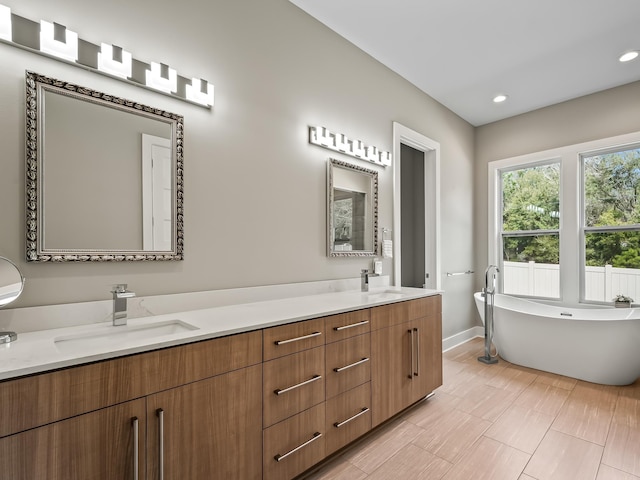 bathroom featuring a bath and vanity