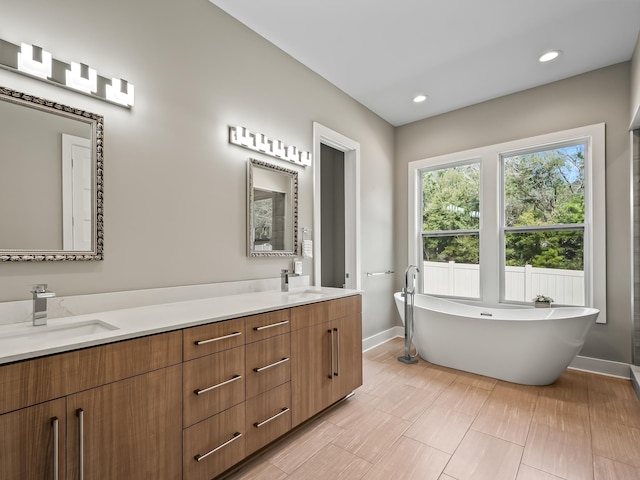 bathroom with vanity and a bathtub