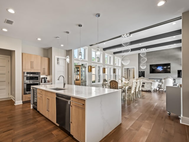 kitchen with dishwasher, sink, dark hardwood / wood-style floors, an island with sink, and light brown cabinetry