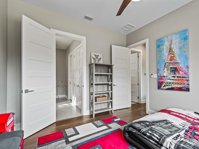 bedroom featuring ceiling fan and dark hardwood / wood-style floors