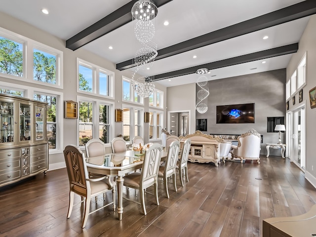 dining room with dark hardwood / wood-style floors, beam ceiling, a high ceiling, and a chandelier