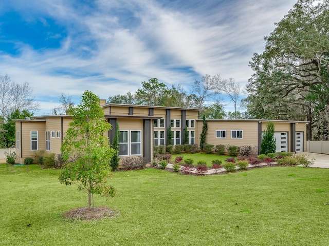 rear view of property with a lawn and a garage