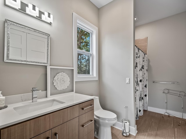 bathroom with hardwood / wood-style flooring, vanity, toilet, and a shower with curtain