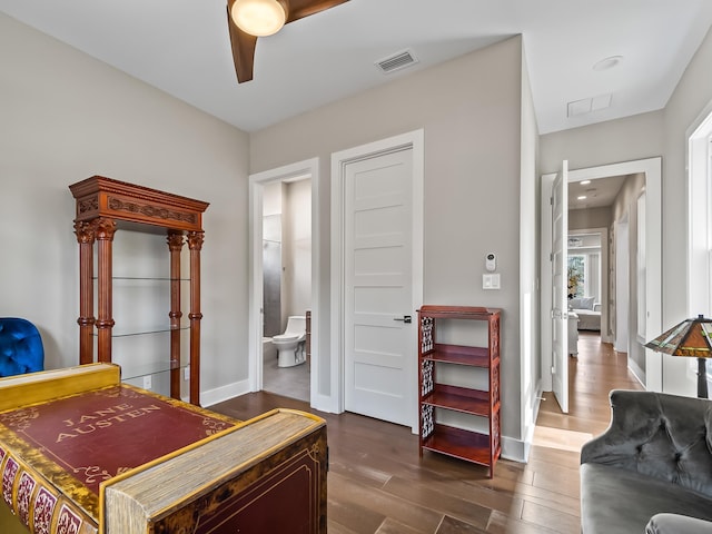 bedroom featuring hardwood / wood-style floors, connected bathroom, and ceiling fan