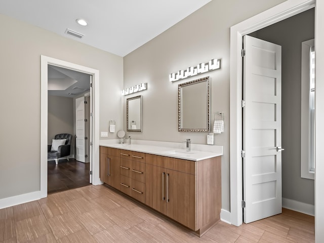 bathroom with hardwood / wood-style floors and vanity