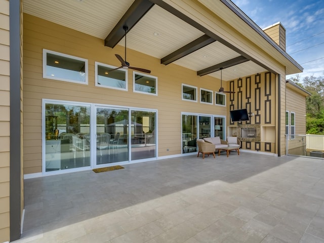 back of house with an outdoor living space with a fireplace, ceiling fan, and a patio area