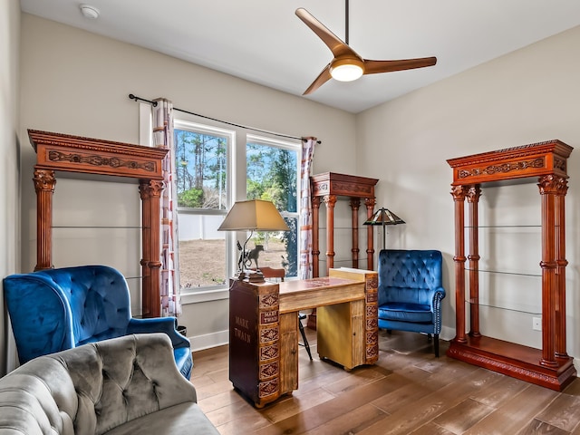 sitting room featuring hardwood / wood-style floors and ceiling fan