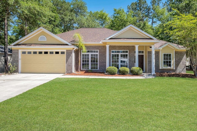 view of front of house featuring a garage and a front lawn