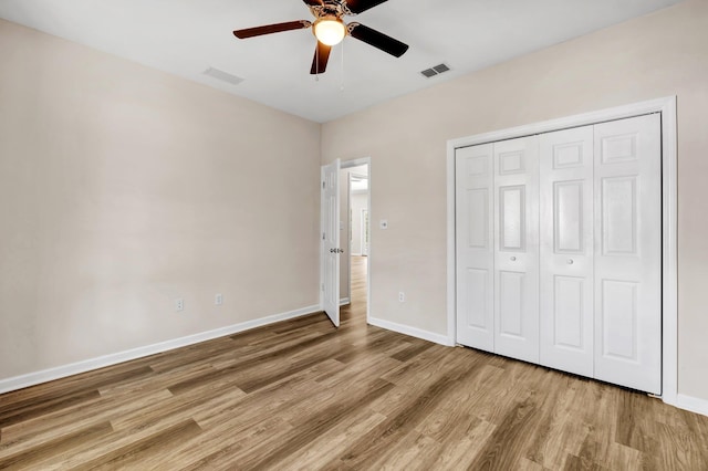 unfurnished bedroom featuring a closet, ceiling fan, and light hardwood / wood-style flooring