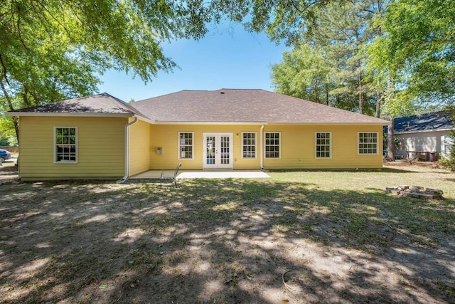 back of property with a patio area, french doors, and a lawn